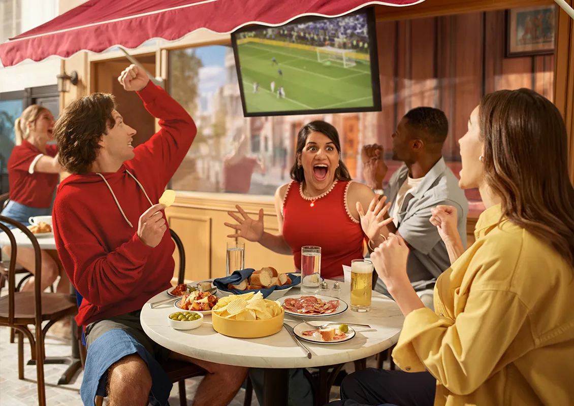 Group of people excited watching soccer
